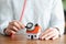 Person listens through stethoscope to wall and roof of house