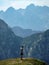 A person looking out at the dramatic and shear landscape of the Julian Alps