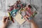 Person making earings from colorful beads and needles