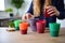 person, making their morning coffee with reusable and eco-friendly cups