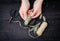 Person making white sage Salvia apiana smudge stick at home with homegrown sage leaves.