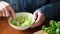 Person mashing avocado in bowl