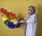 Person in medical costume and lion mask proudly waves LGBTI flag. Concept of gender identity at work