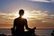 Person, meditation and yoga in beach sunset for zen fitness, calm exercise and mindfulness or holistic wellness in