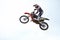 Person, motorcycle and air jump adventure as professional in action, competition or fearless. Bike rider, off road