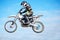 Person, motorcycle and air jump in blue sky as professional in action, competition or fearless. Bike rider, off road