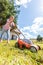 Person mowing green grass