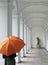 Person with a orange umbrella standing