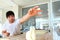 The person is out of focus. A piece of dough falls on the table from the hands of a young Baker. The process of making tortillas.