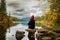 A person overlooking a calm lake with a reflection