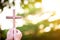 person palm hands to hold holy cross, crucifix to worship.