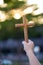 Person palm hands to hold holy cross, crucifix to worship. christian in catholic Eucharist bless god ceremony. People and religion