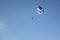 The person with a parachute on a cable flying in the sky
