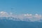 Person paragliding over alpine landscape with panoramic view of majestic mountain range Julian Alps seen from Gerlitzen Alpe