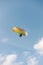 A person paragliding in a sky on a clear day