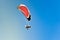 Person parasailing in the blue sky