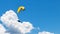 Person parasailing in the cloudy sky