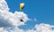 Person parasailing in the cloudy sky