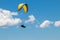 Person parasailing in the cloudy sky