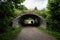 Person passing through an underpass under a railway line..