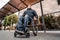 Person with a physical disability waiting for city transport with an accessible ramp.