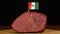 Person placing decorative Mexican flag toothpicks into piece of red meat.