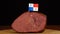 Person placing decorative Panama flag toothpicks into piece of red meat.