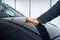 A person polishes the bonnet on his car