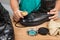 Person polishing a worn out men boots shoe