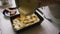 Person pouring dough into form baking apple pie