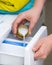 Person pouring fabric softener into washing machine