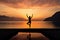 a person practicing yoga at sunrise by the sea