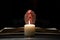 Person Praying with Hands Over Bible Illuminated by Candle Light