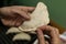 A person is preparing vegan and vegetarian Argentinian empanadas with a stuffing