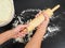 Person preparing a wooden rolling pin