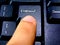 A person presses the enter key with their finger