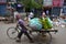 A person pulling a cart full of banana . Street Market . Delhi.