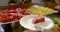 Person puts watermelon slices on plate with silver fork