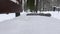 person raises the mitten from the bench and shakes it off the snow