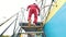 The person in red suit going upstairs towards the aerodynamic tube