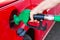 Person refueling a car at gas station