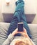 Person relaxing and using smart phone
