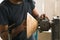 Person repairing a machine in his workshop. Carpenter performing maintenance on his tools.