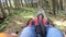 Person rides in fast rodelbahn sledding in mountains in woods among trees