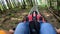 Person rides in fast rodelbahn sledding in mountains in woods among trees