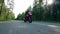 A person rides a motorbike on a road fast.