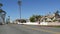 Person riding bicycle, palm trees and people in coastal pacific resort Oceanside, California USA.