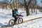 A person is riding a fat tire snow bike in Winter.