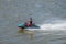 Person is riding speed boat, water scooter at Elbe river near downtown in Magdeburg, Germany, Summer, closeup