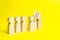 The person`s figure comes out of the line with a sign on an yellow background. An angry mob of wooden figures of people